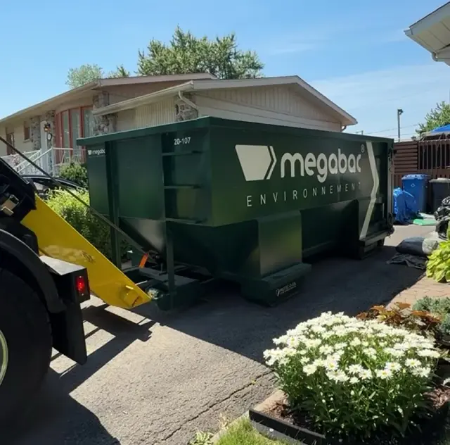 PROTEC-O-SOL planks under a Megabac dumpster on an asphalt driveway